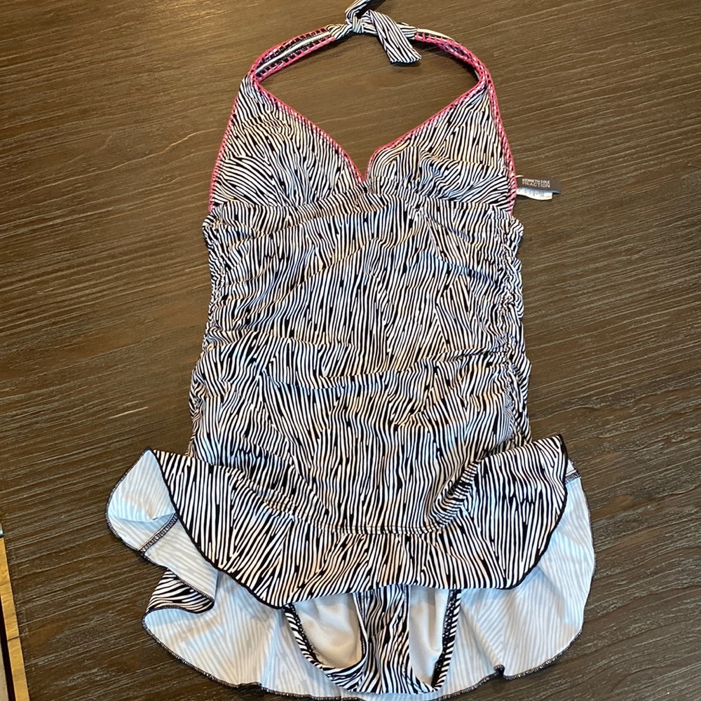 Kenneth Cole one piece swimsuit in size small. Skirt bottom.